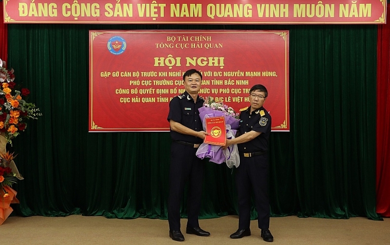 Deputy Director General of the General Department of Customs Luu Manh Tuong awards the appointment decision and gives flowers to congratulate Mr. Le Viet Hung. Photo: Q.H