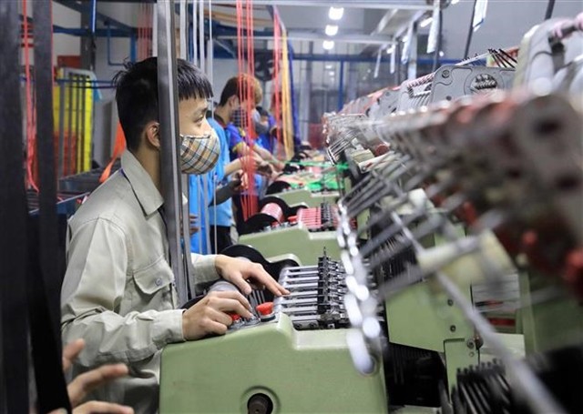 Workers during a working shift at a packaging factory in the northern province of Hung Yen. (Photo: VNA)