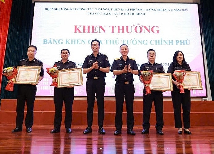 On behalf of the delegation, Deputy Director General of Vietnam Customs Dinh Ngoc Thang (third from right) and Deputy Director of HCMC Customs Department Do Thanh Quang presented the Prime Minister's Certificates of Merit to individuals.