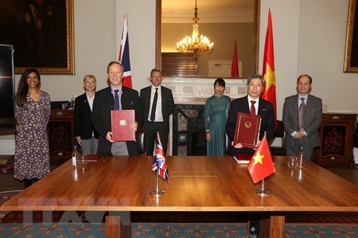 Vietnamese Ambassador to the UK Tran Ngoc An (R) and UK Ambassador to Vietnam Gareth Edward Ward (L) sign UKVFTA